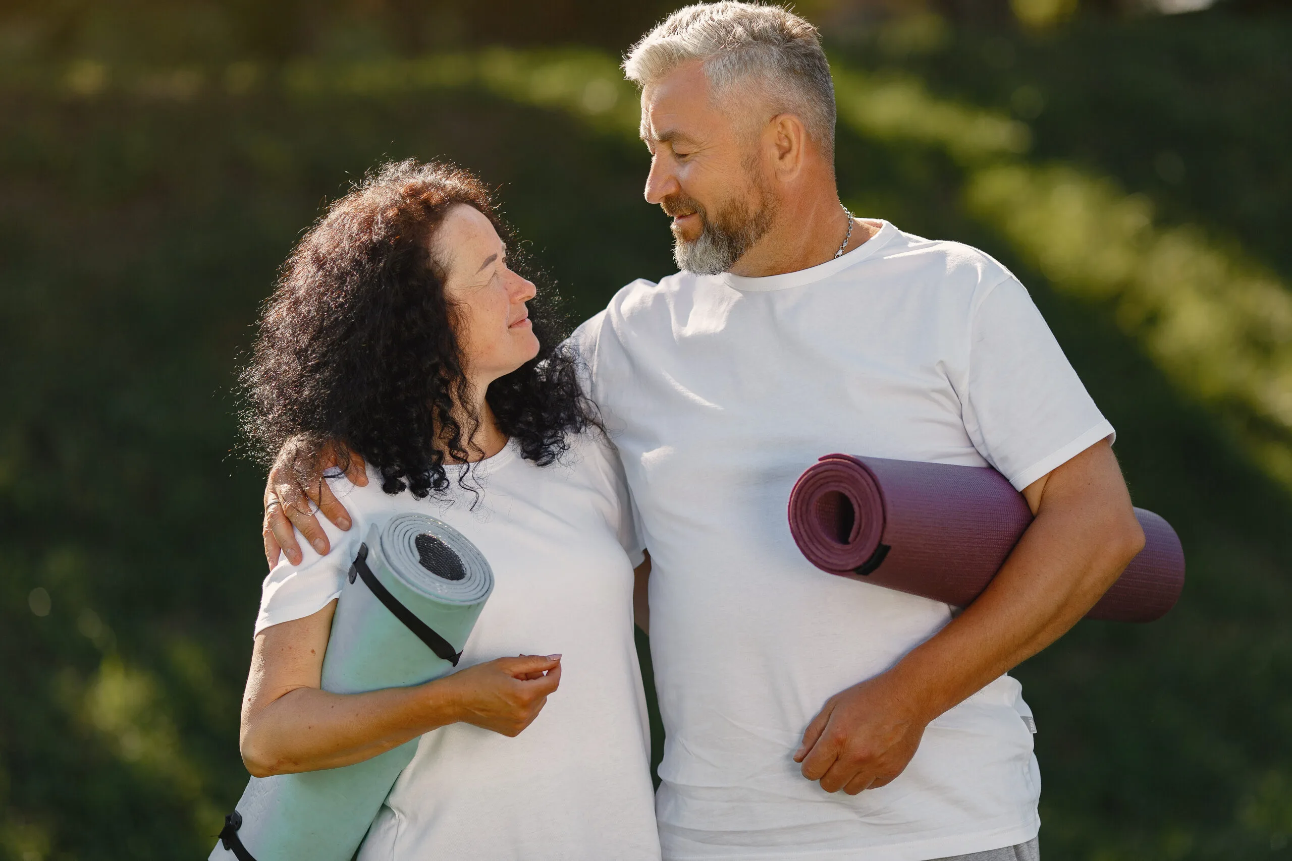 healthy active middle aged couple outdoors walking nature energy